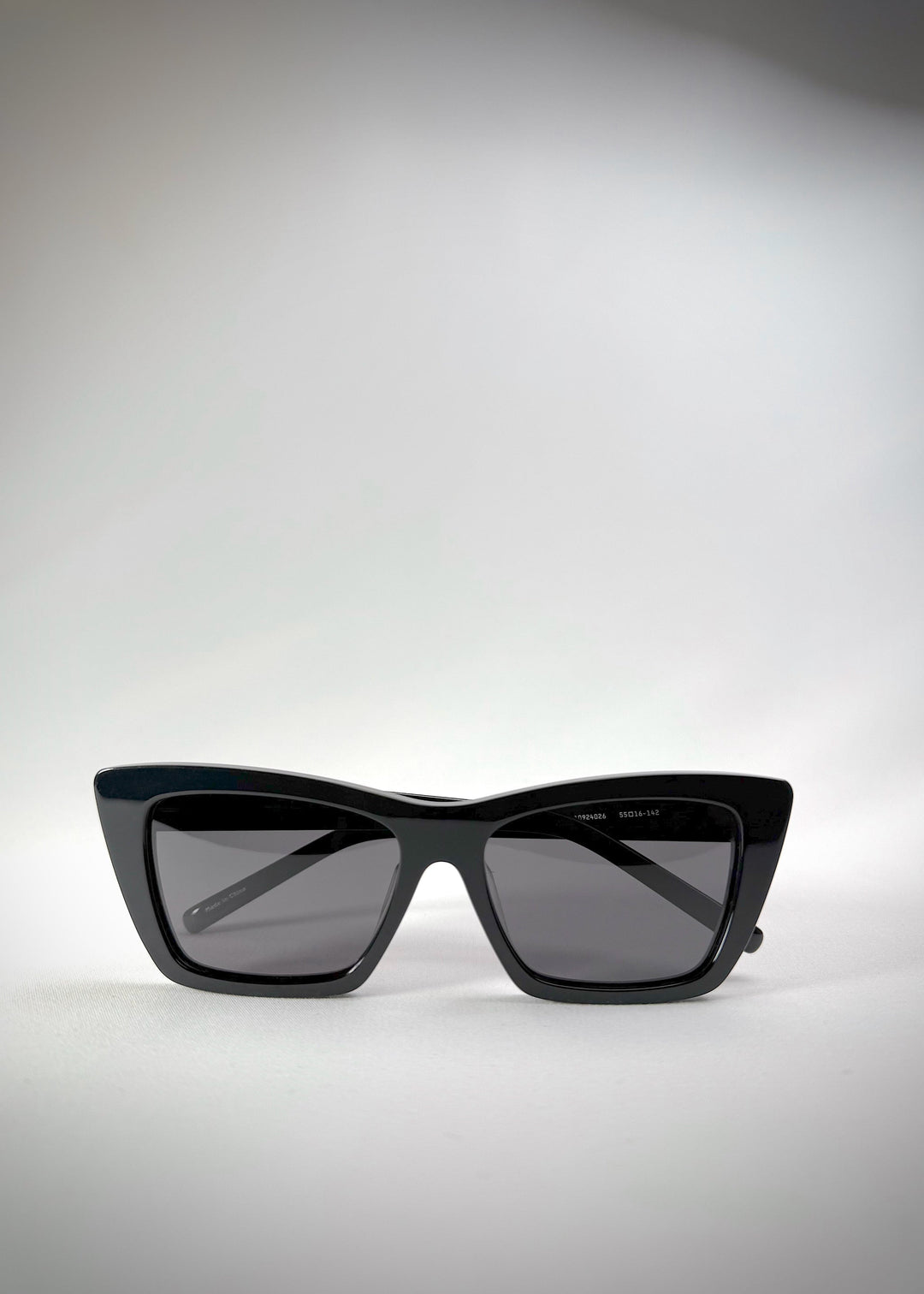 Folded view of Aquila Black sunglasses, showing the folded temples and acetate craftsmanship. 