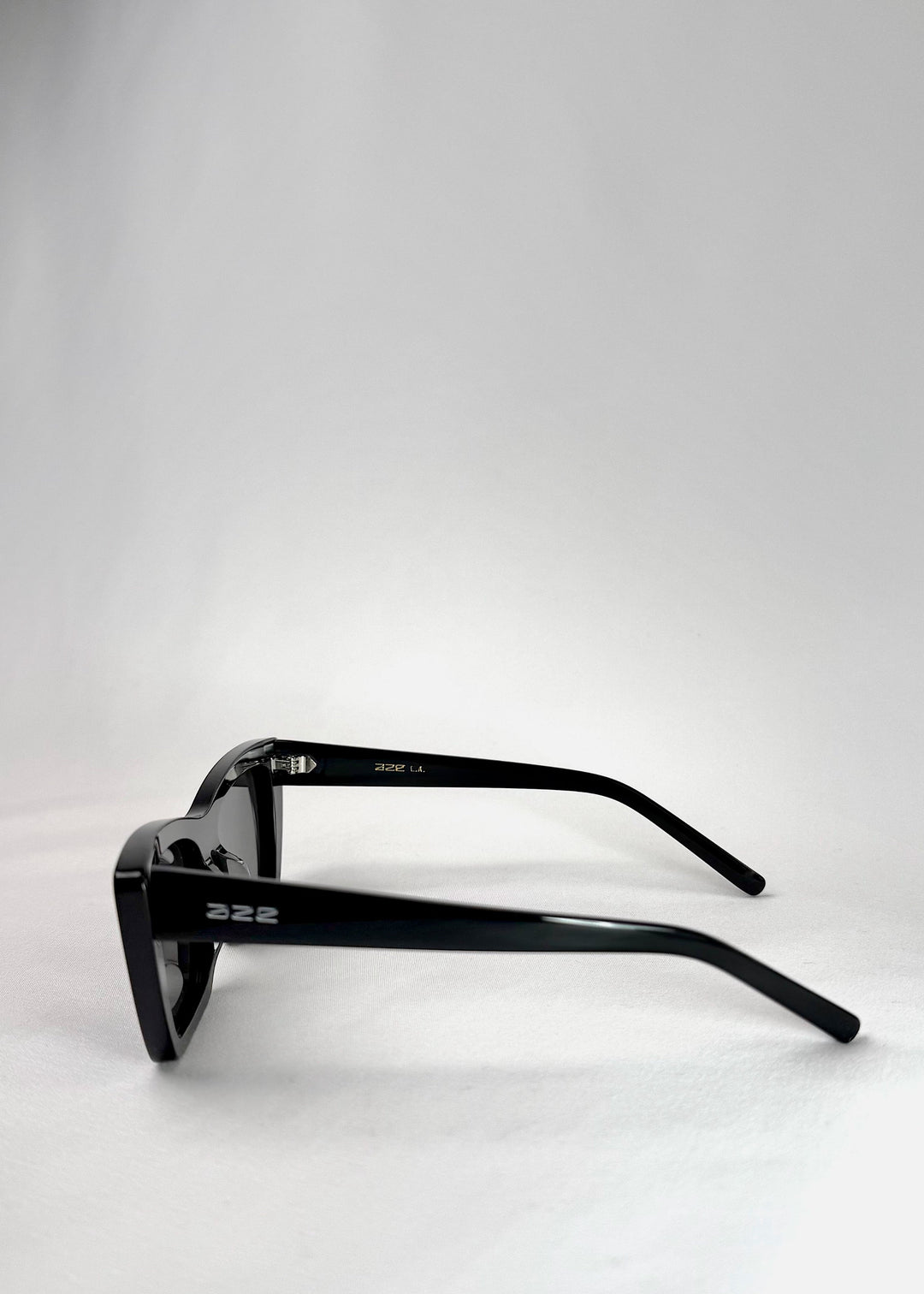 Side view of Aquila Black prescription sunglasses, showing the bold cat-eye frame and temple profile. 