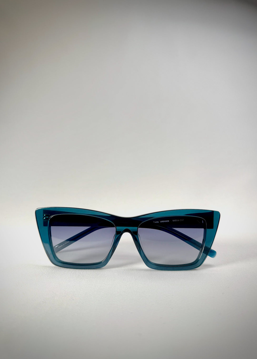 Folded view of Aquila Blue sunglasses, showing the folded temples and acetate frame. 