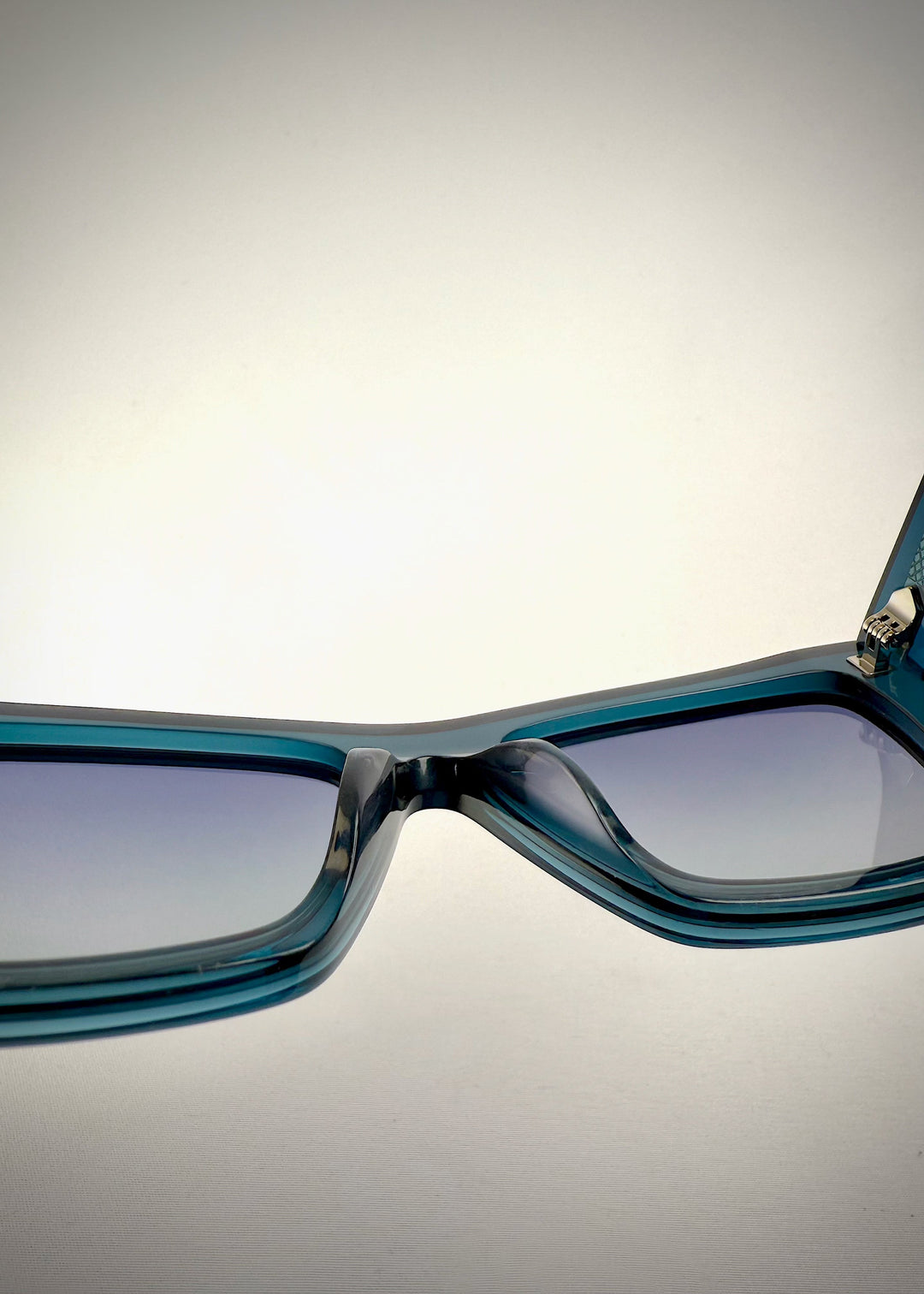 Close-up of the UV400 polarized lenses on Aquila Blue, showing the lens tint and clarity. 