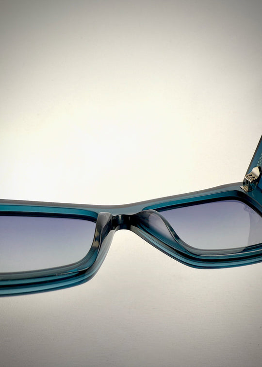 Close-up of the UV400 polarized lenses on Aquila Blue, showing the lens tint and clarity. 