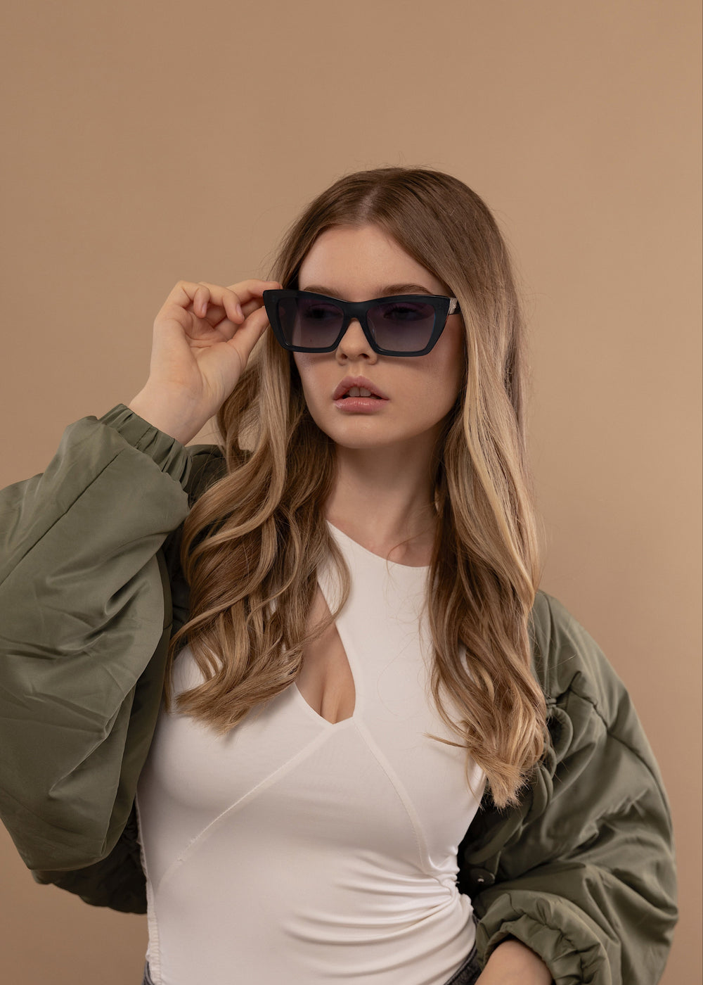 Female model wearing Aquila - Blue prescription sunglasses, showcasing its bold and stylish look.
