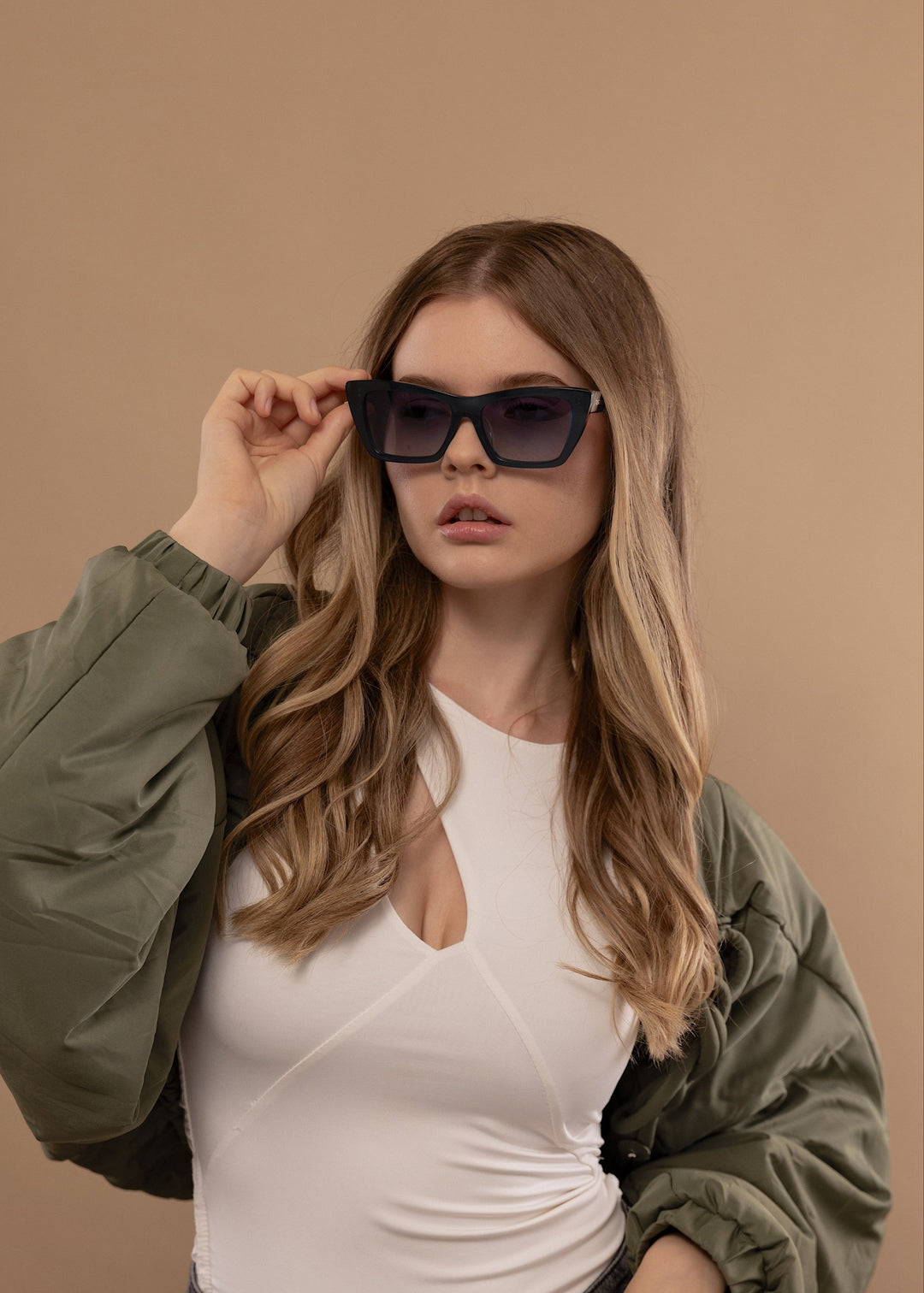 Female model wearing Aquila Blue prescription sunglasses, styled for a bold everyday look. 