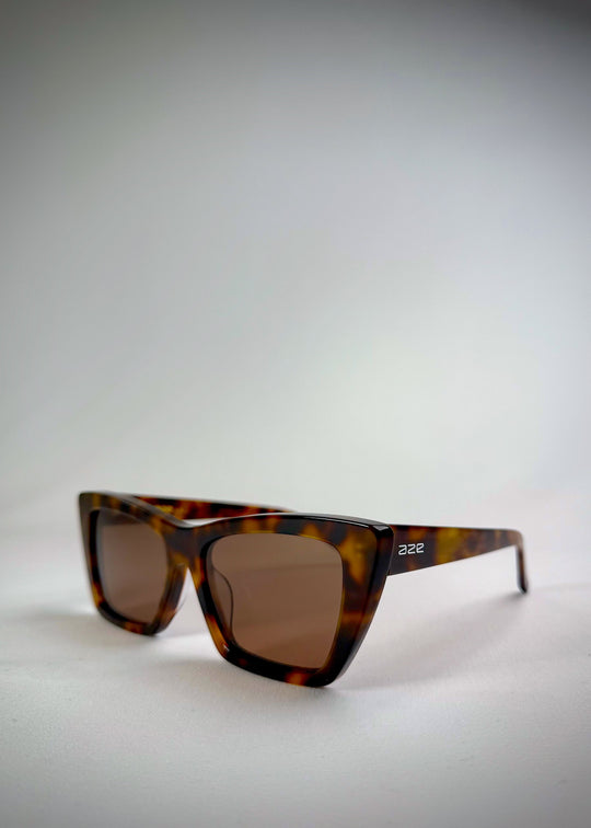 Angled perspective of Aquila Tortoiseshell sunglasses, emphasizing the sharp frame design and acetate texture. 