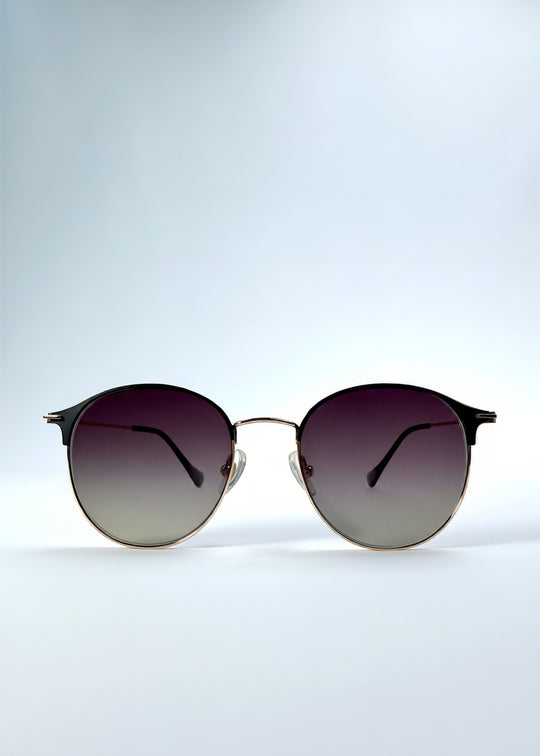 Front view of AZE Aster Line sunglasses in Duskgold, featuring a gold-tone rounded frame and plum-to-amber gradient lenses, showing the full front silhouette.