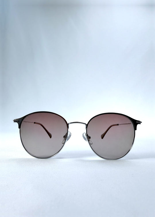Front view of AZE Aster Line sunglasses in Mocha Dusk, featuring a silver-tone rounded frame and taupe gradient lenses, showing the full front silhouette.