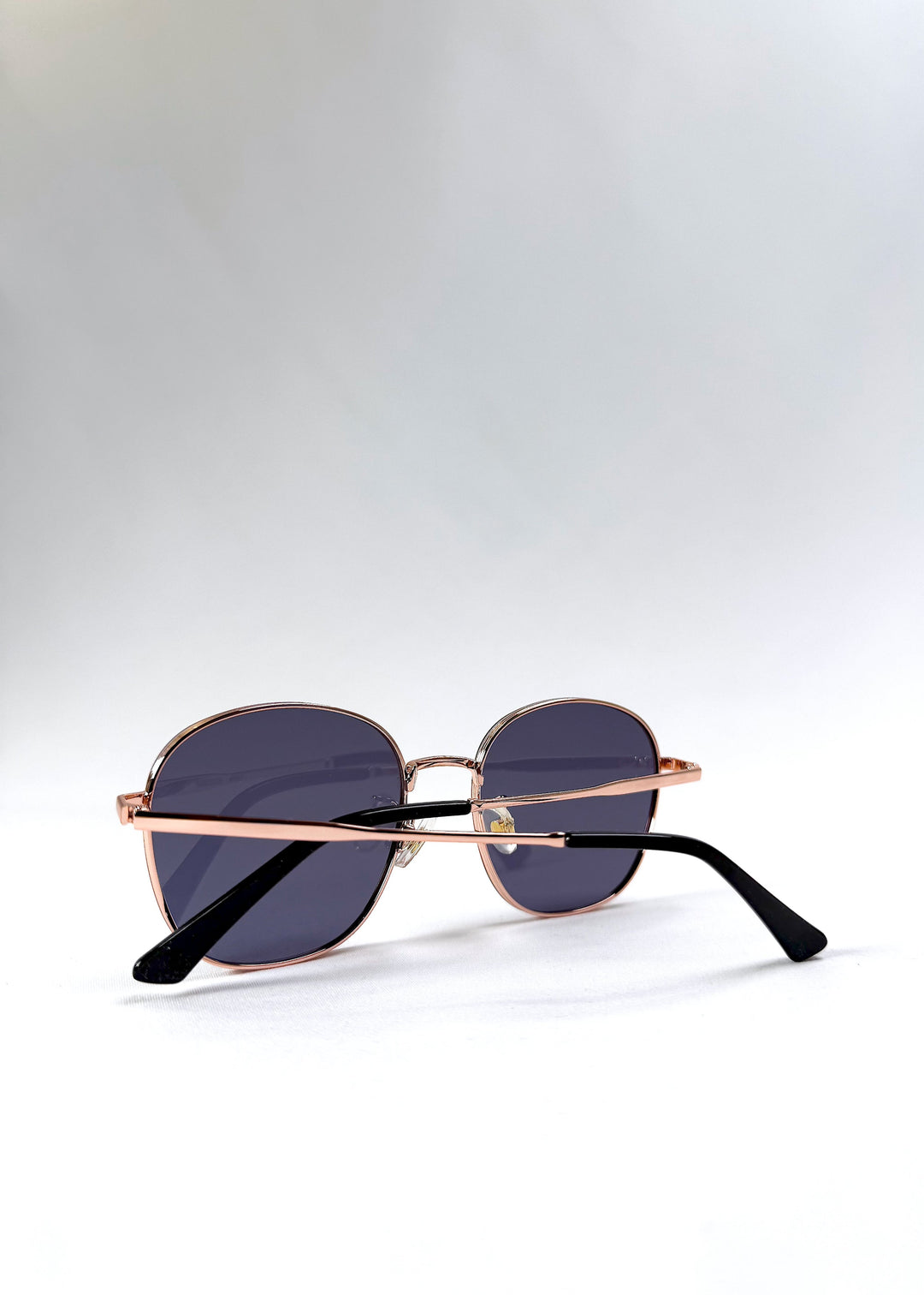 Astris Midnight Blue sunglasses – back view with curved temple tips and transparent nose pads. 