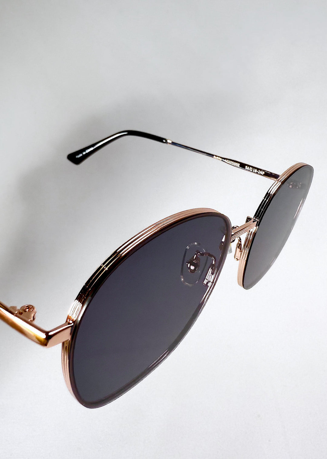 Astris Midnight Blue sunglasses – close-up of navy HD nylon lenses with semi-flat curvature. 