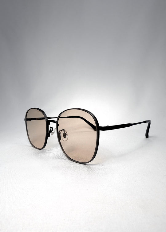 Astris Satin Bronze sunglasses angled front view highlighting soft curves and minimalist silhouette. 