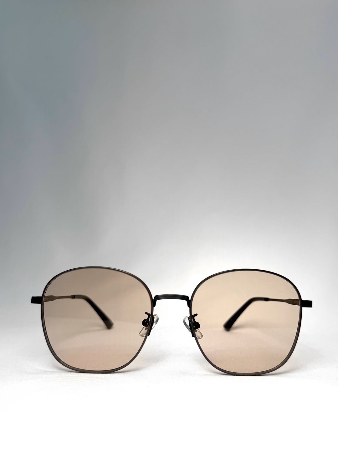 Front view of Astris sunglasses in Satin Bronze with rounded square lenses and warm tea tint.