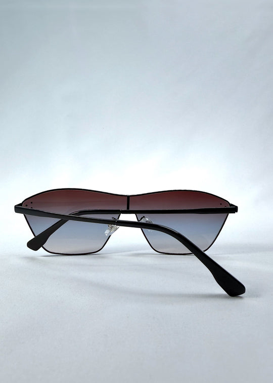 Folded view of Atlas Shield sunglasses in Midnight Eclipse, featuring one-piece shield lens, slim metal frame, and dark gradient tint, showing the folded temples and frame profile. 