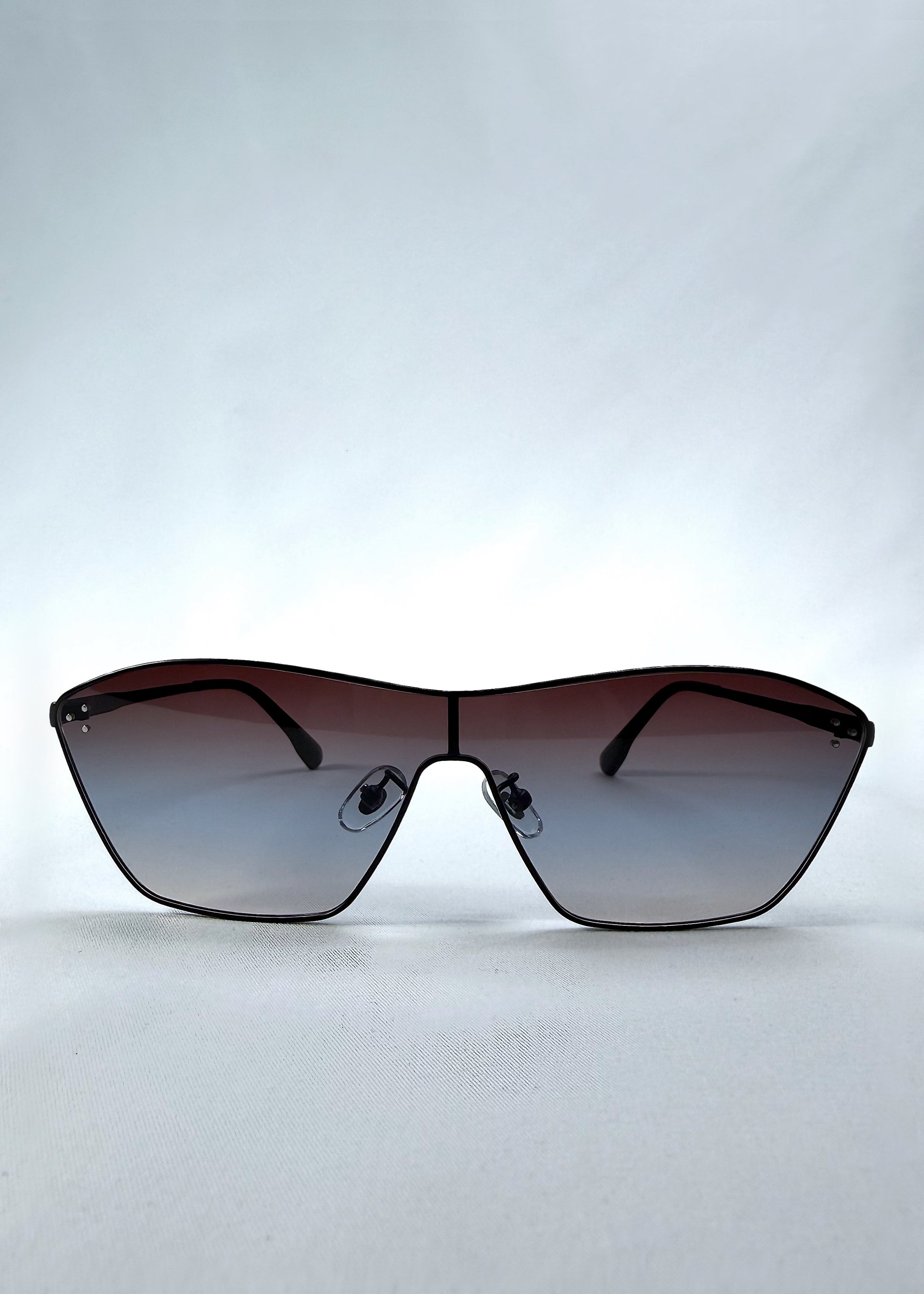 Front view of Atlas Shield sunglasses in Midnight Eclipse, featuring one-piece shield lens, slim metal frame, and dark gradient tint, showing the full front silhouette.