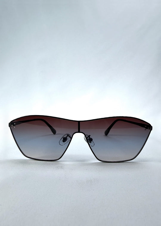 Front view of Atlas Shield sunglasses in Midnight Eclipse, featuring one-piece shield lens, slim metal frame, and dark gradient tint, showing the full front silhouette. 