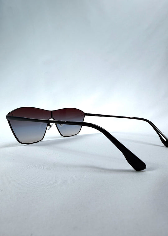 Side view of Atlas Shield sunglasses in Midnight Eclipse, featuring one-piece shield lens, slim metal frame, and dark gradient tint, showing the lens shape and temple profile. 