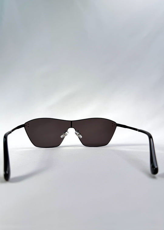 Back view of Atlas Shield sunglasses in Slate Smoke, featuring one-piece shield lens, slim metal frame, and full grey tint, showing the inside frame and open temples. 
