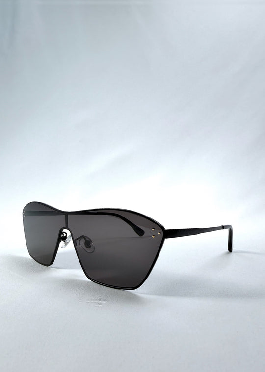 Three-quarter front view of Atlas Shield sunglasses in Slate Smoke, featuring one-piece shield lens, slim metal frame, and full grey tint, showing the front shape and temple profile.
