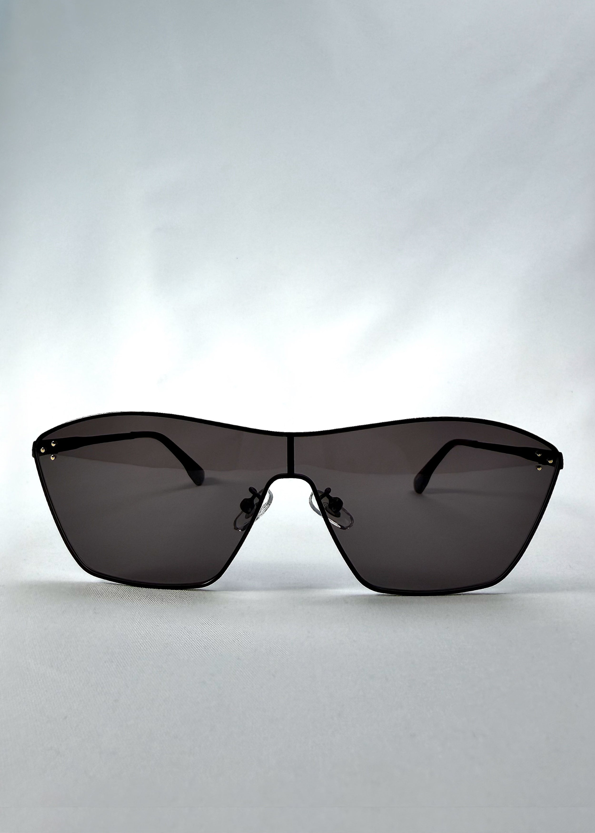 Front view of Atlas Shield sunglasses in Slate Smoke, featuring one-piece shield lens, slim metal frame, and full grey tint, showing the full front silhouette.