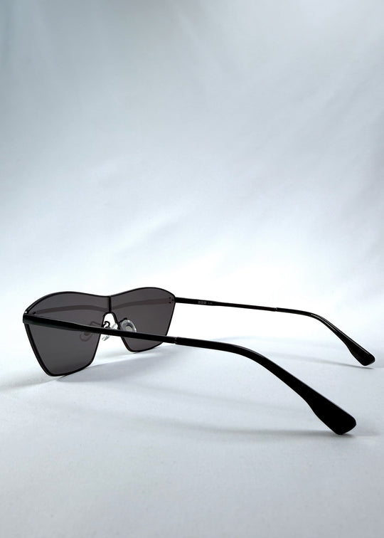 Side view of Atlas Shield sunglasses in Slate Smoke, featuring one-piece shield lens, slim metal frame, and full grey tint, showing the lens shape and temple profile.