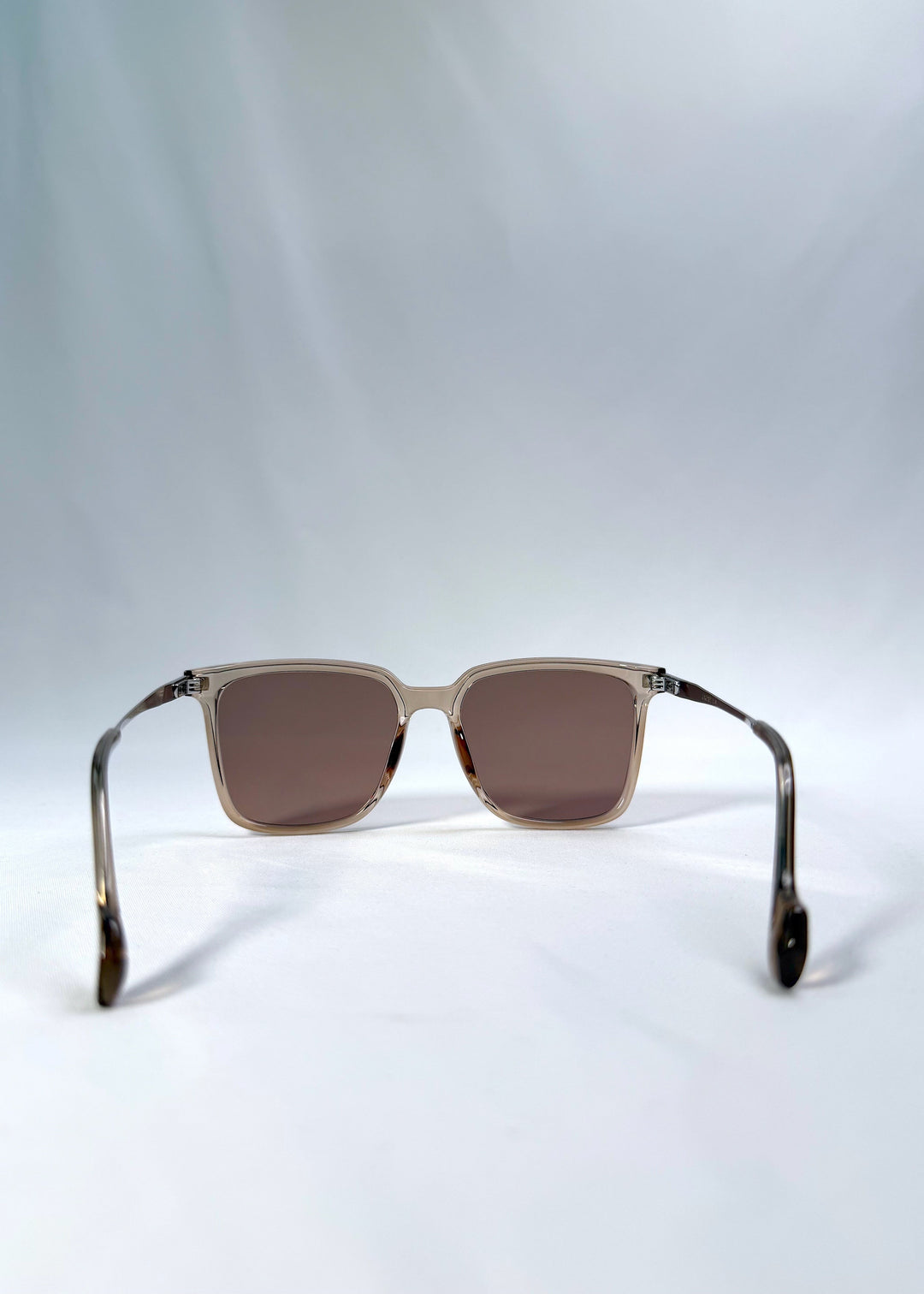 Back view of Auralis sunglasses in Mocha Bronze, featuring mocha bronze frame and warm brown lenses, showing the inside frame and open temples. 