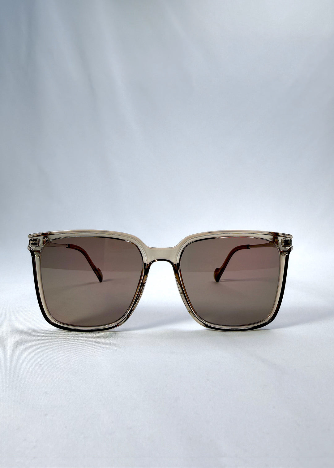 Front view of Auralis sunglasses in Mocha Bronze, featuring mocha bronze frame and warm brown lenses, showing the full front silhouette.