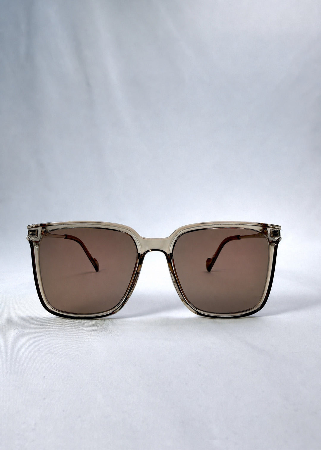 Front view of Auralis sunglasses in Mocha Bronze, featuring mocha bronze frame and warm brown lenses, showing the full front silhouette.