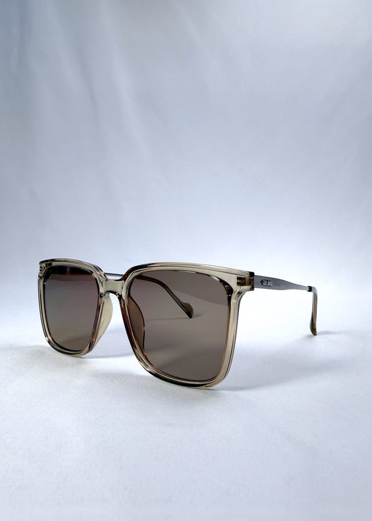 Left three-quarter front view of Auralis sunglasses in Mocha Bronze, featuring mocha bronze frame and warm brown lenses, showing the front shape from the left side. 