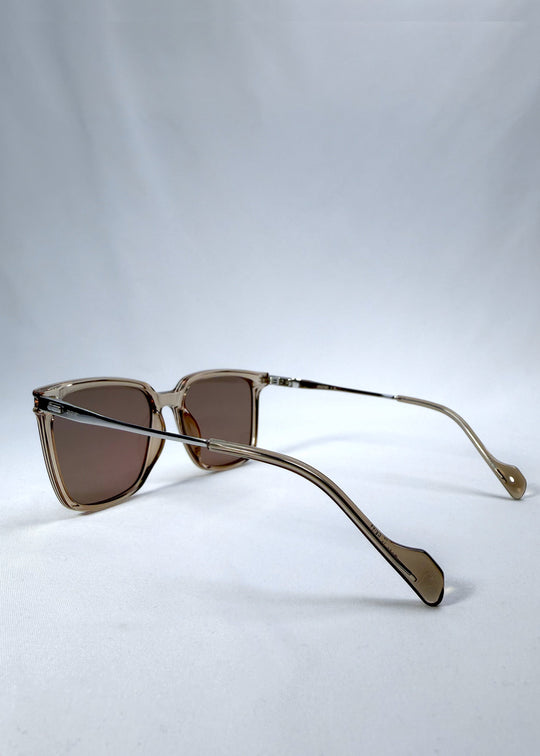 Side-angle view of Auralis sunglasses in Mocha Bronze, featuring mocha bronze frame and warm brown lenses, showing the lens shape and side temple profile. 