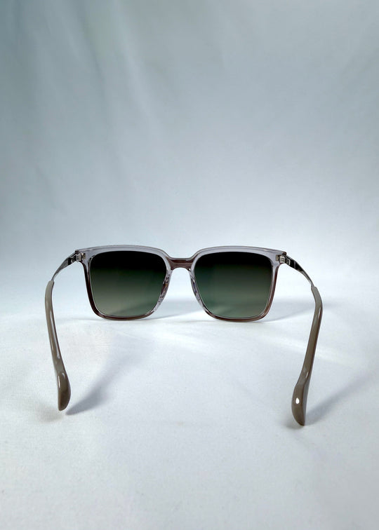 Back view of Auralis sunglasses in Rose Graphite, featuring rose graphite frame and green gradient lenses, showing the inside frame and open temples.