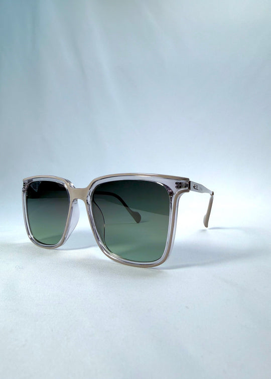 Three-quarter front view of Auralis sunglasses in Rose Graphite, featuring rose graphite frame and green gradient lenses, showing the front shape and temple profile. 
