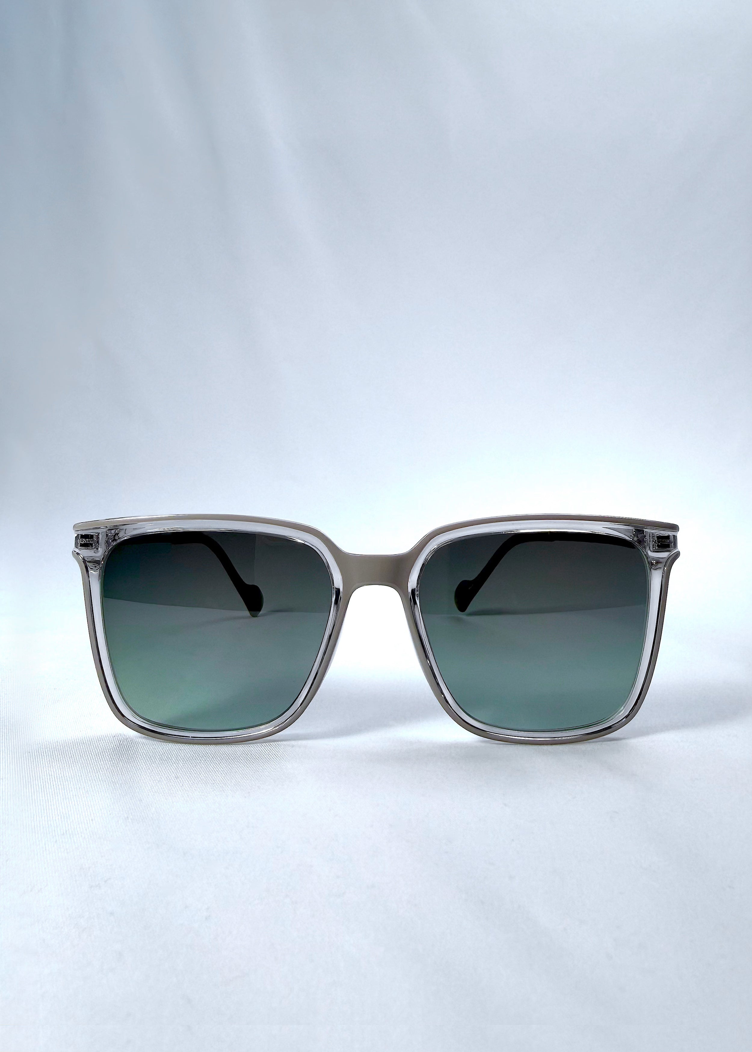 Front view of Auralis sunglasses in Rose Graphite, featuring rose graphite frame and green gradient lenses, showing the full front silhouette.