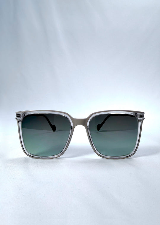Front view of Auralis sunglasses in Rose Graphite, featuring rose graphite frame and green gradient lenses, showing the full front silhouette.