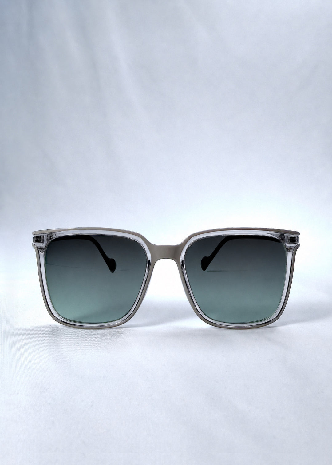 Front view of Auralis sunglasses in Rose Graphite, featuring rose graphite frame and green gradient lenses, showing the full front silhouette.