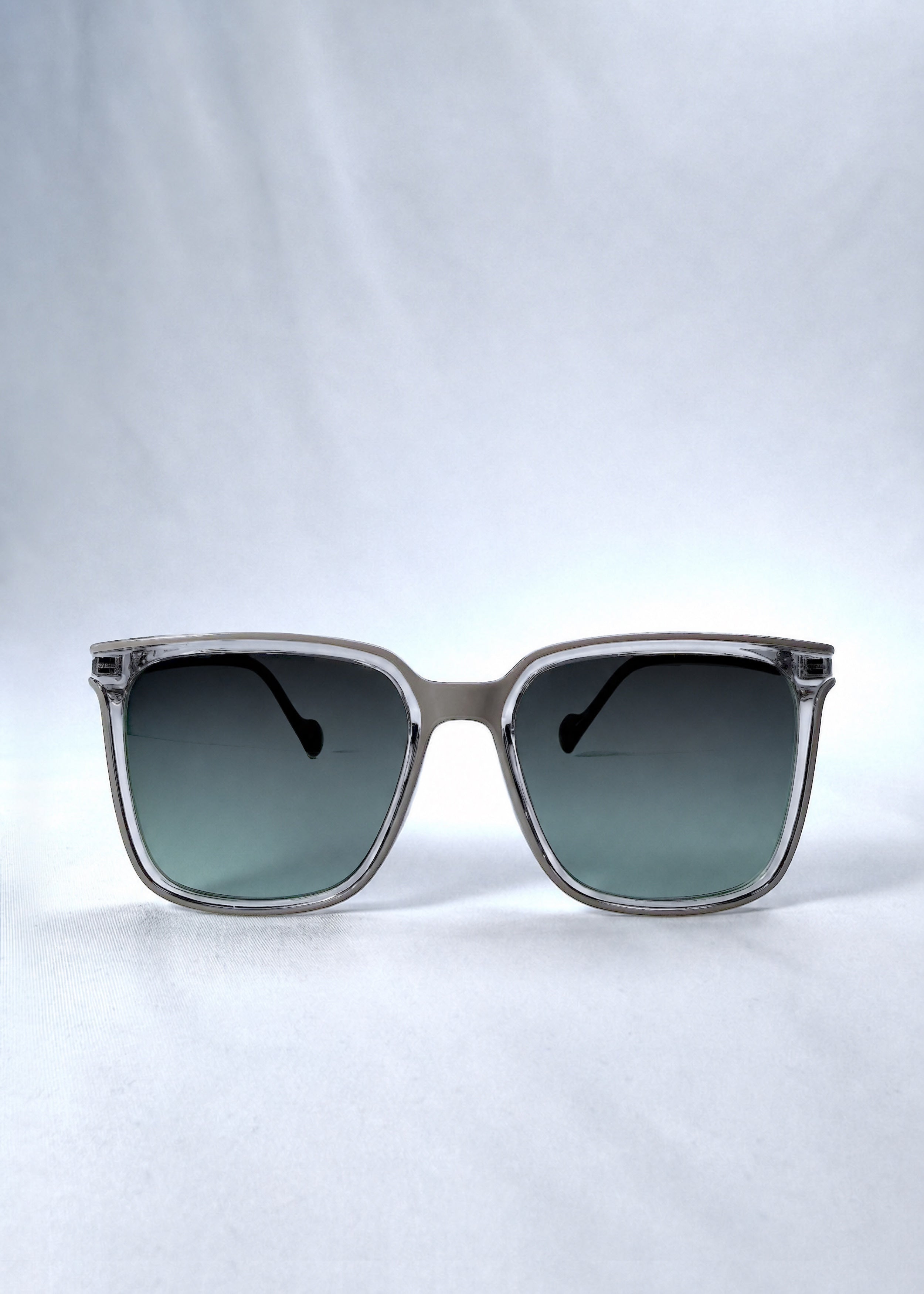 Front view of Auralis sunglasses in Rose Graphite, featuring rose graphite frame and green gradient lenses, showing the full front silhouette.