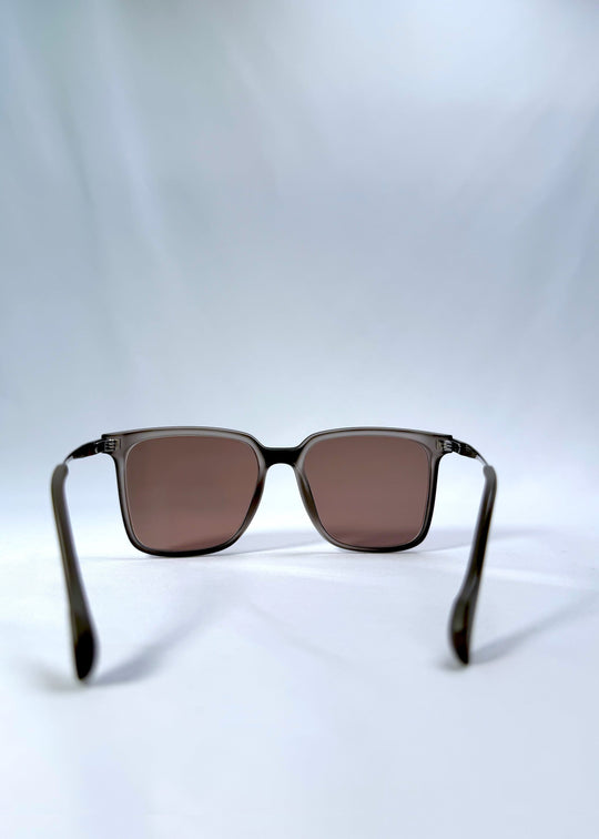 Back view of Auralis sunglasses in Sand Amber, featuring sand amber frame and brown lenses, showing the inside frame and open temples. 