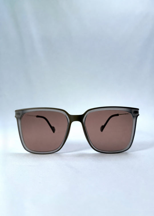 Front view of Auralis sunglasses in Sand Amber, featuring sand amber frame and brown lenses, showing the full front silhouette.