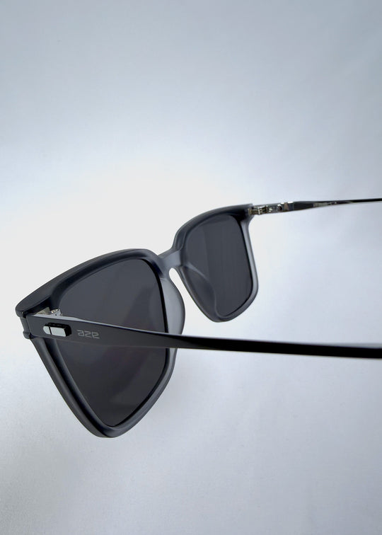 Close rear-angle view of Auralis sunglasses in Sand Haze showing the frame and temple connection. 