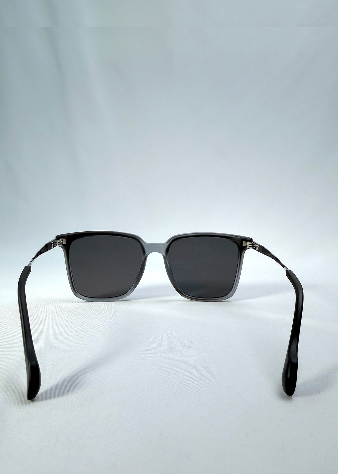 Back view of Auralis sunglasses in Sand Haze, featuring sand-toned frame and dark lenses, showing the inside frame and open temples.