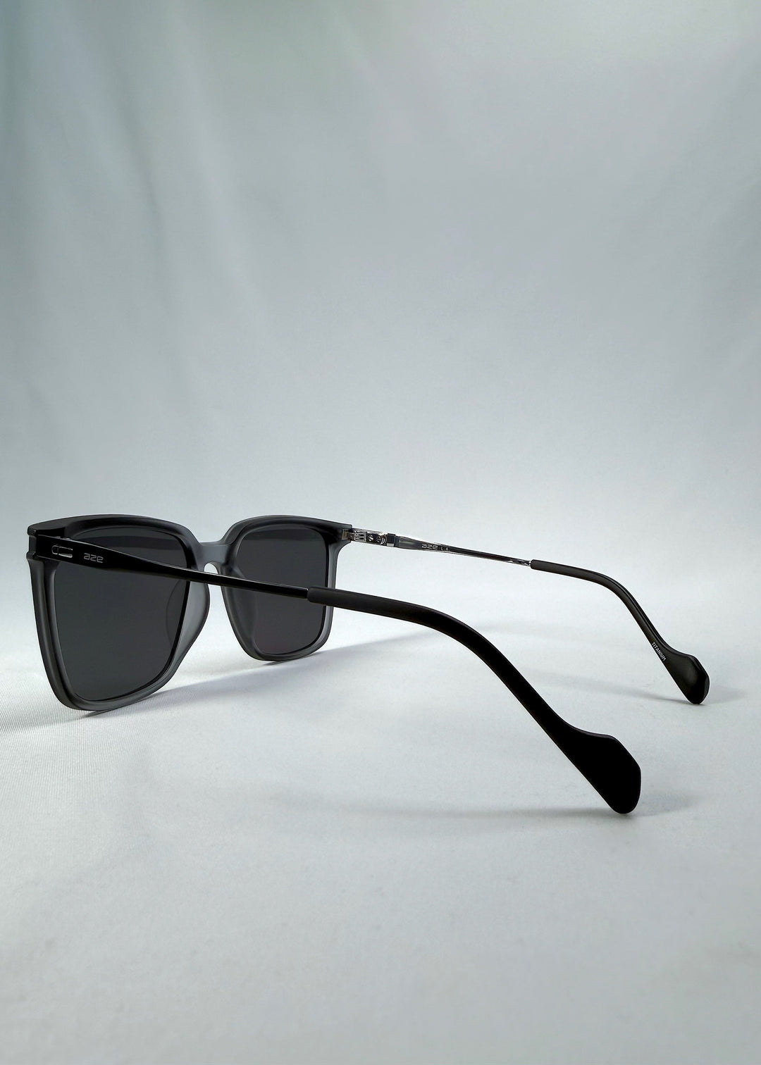 Rear three-quarter view of Auralis sunglasses in Sand Haze showing the open temples and inner frame. 