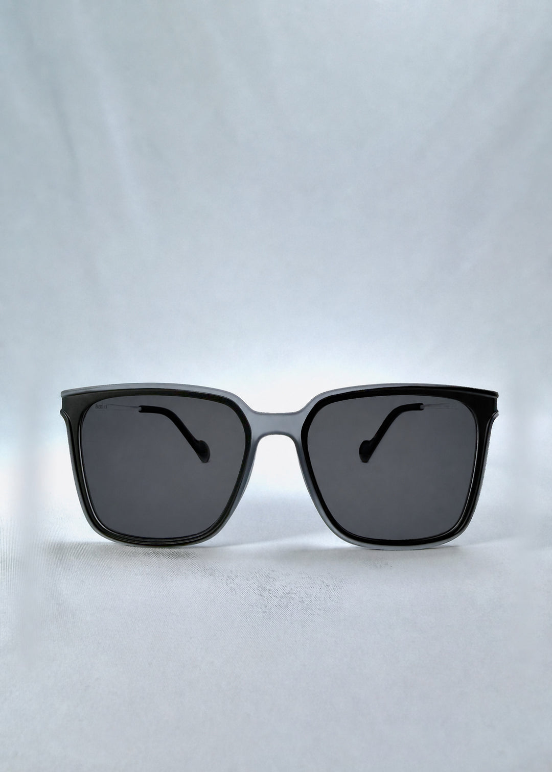 Front view of Auralis sunglasses in Sand Haze, featuring sand-toned frame and dark lenses, showing the full front silhouette.