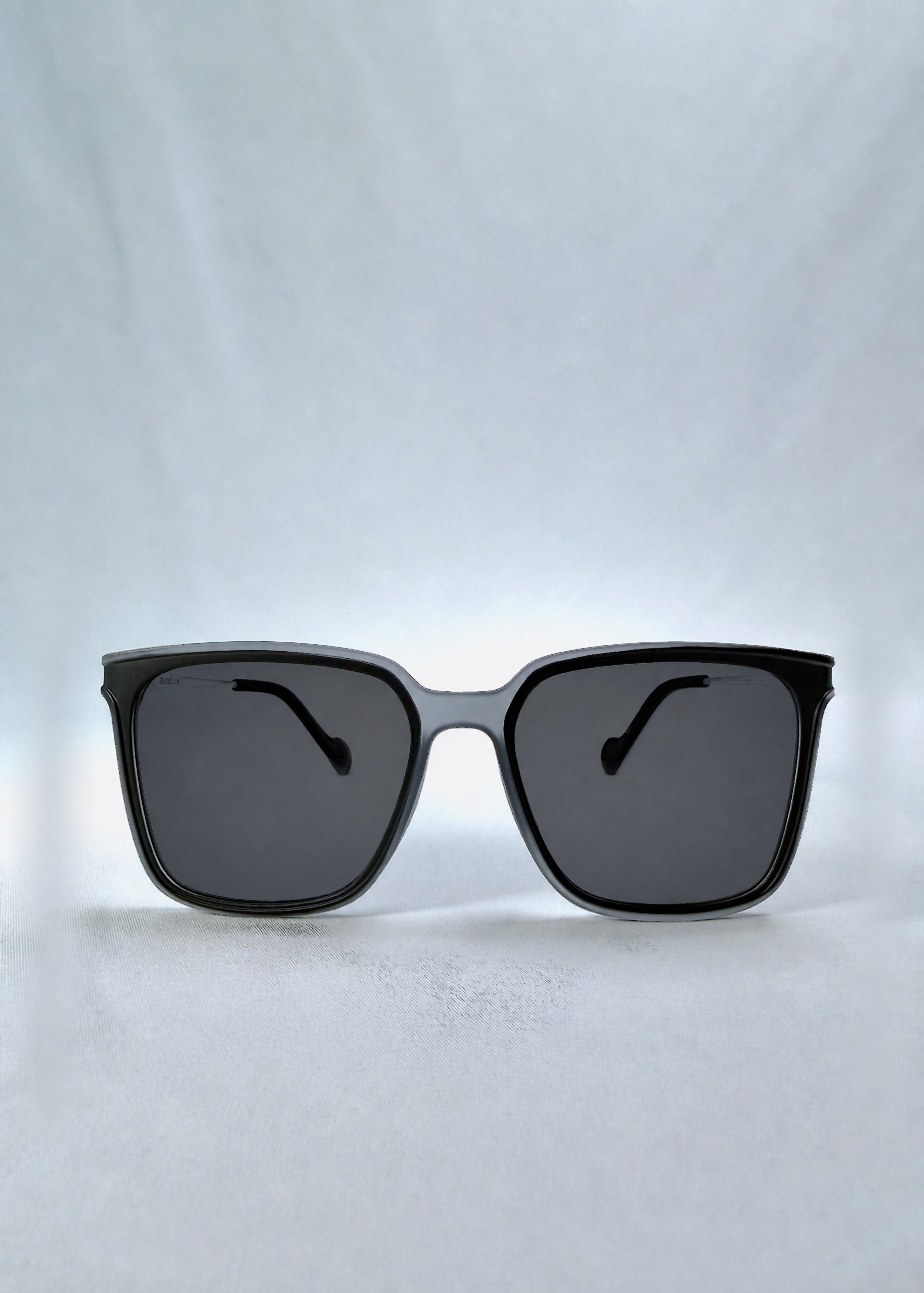 Front view of Auralis sunglasses in Sand Haze, featuring sand-toned frame and dark lenses, showing the full front silhouette.