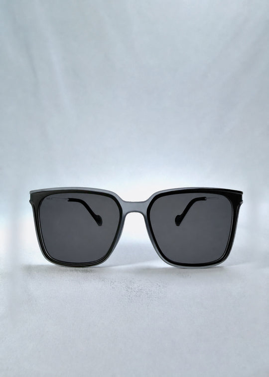 Front view of Auralis sunglasses in Sand Haze, featuring sand-toned frame and dark lenses, showing the full front silhouette.