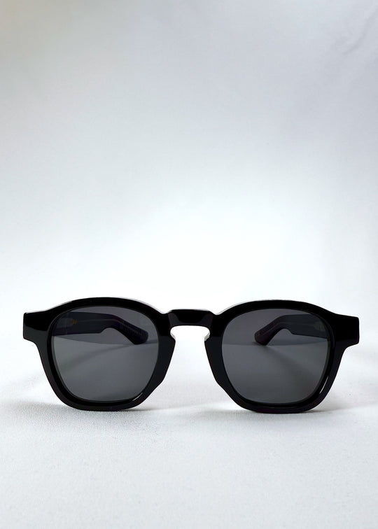 Auren Black sunglasses front view showing the bold round frame and glossy acetate finish. 