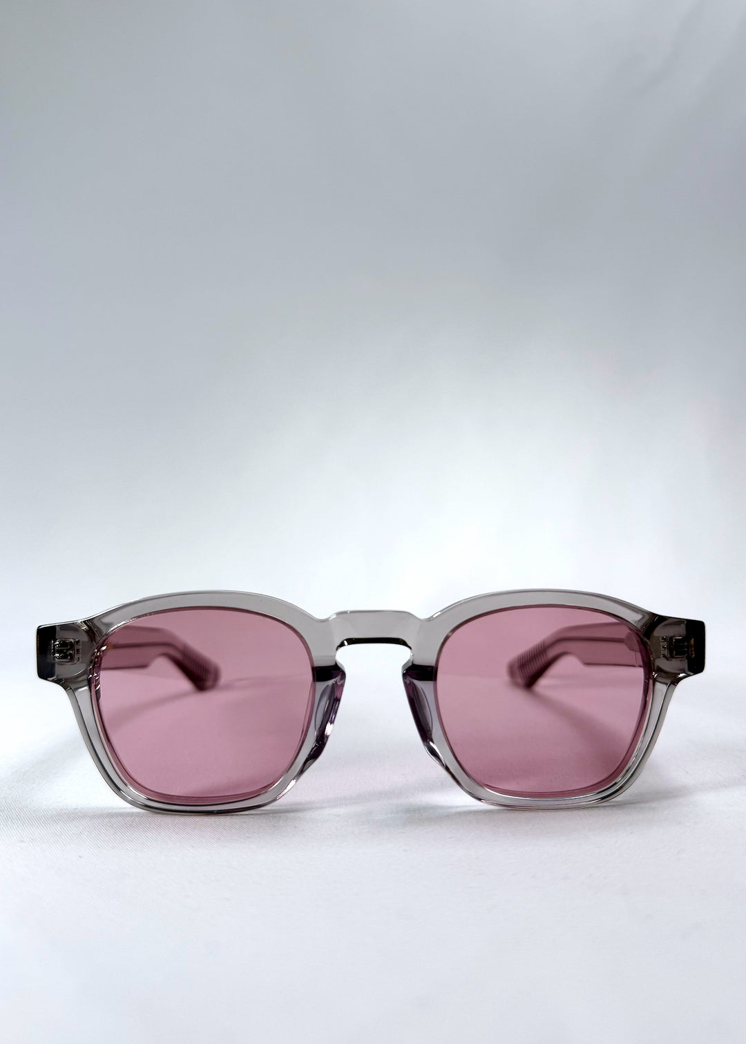 Front view of Auren in Blush Grey showing soft blush-tinted lenses and crystal-clear round acetate frame.