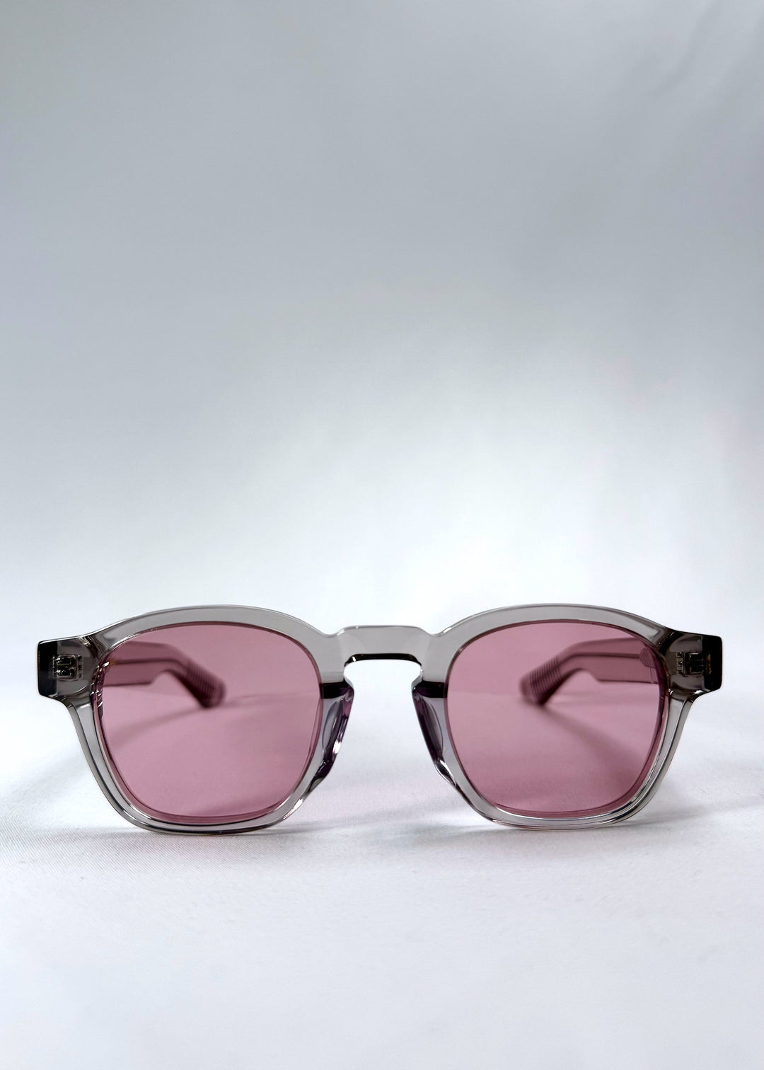 Front view of Auren in Blush Grey showing soft blush-tinted lenses and crystal-clear round acetate frame. 