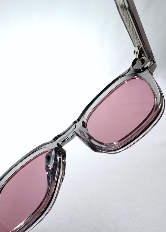 Inside view of Auren Blush Grey sunglasses focusing on the blush lenses and embedded metal hinge details. 