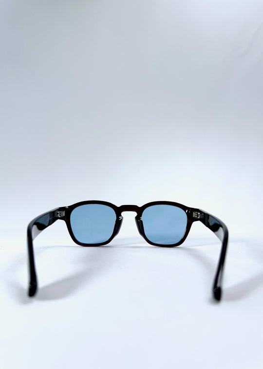 Back view of Auren Mahogany Smoke sunglasses displaying the ergonomic temple curve and polished acetate finish. 