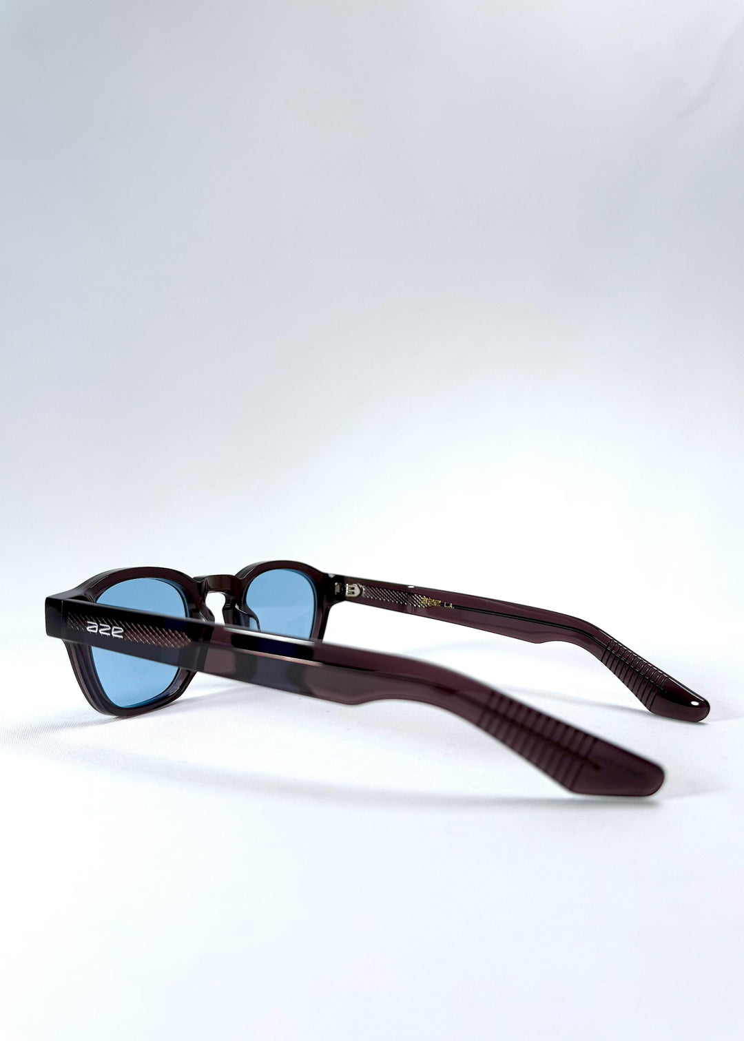 Side view of Auren Mahogany Smoke sunglasses highlighting the sculpted temples and acetate frame details. 