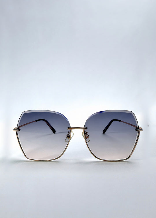 Front view of Aureon sunglasses in Rosé Quartz, featuring rimless metal frame, pale metal temples, and pink-grey gradient lenses, showing the full front silhouette. 