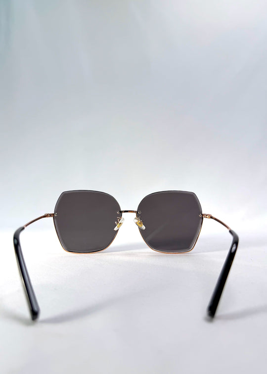 Back view of Aureon sunglasses in Silver Smoke, featuring rimless metal frame, silver temples, and grey lenses, showing the inside frame and open temples. 