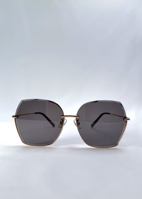 Front view of Aureon sunglasses in Silver Smoke, featuring rimless metal frame, silver temples, and grey lenses, showing the full front silhouette.